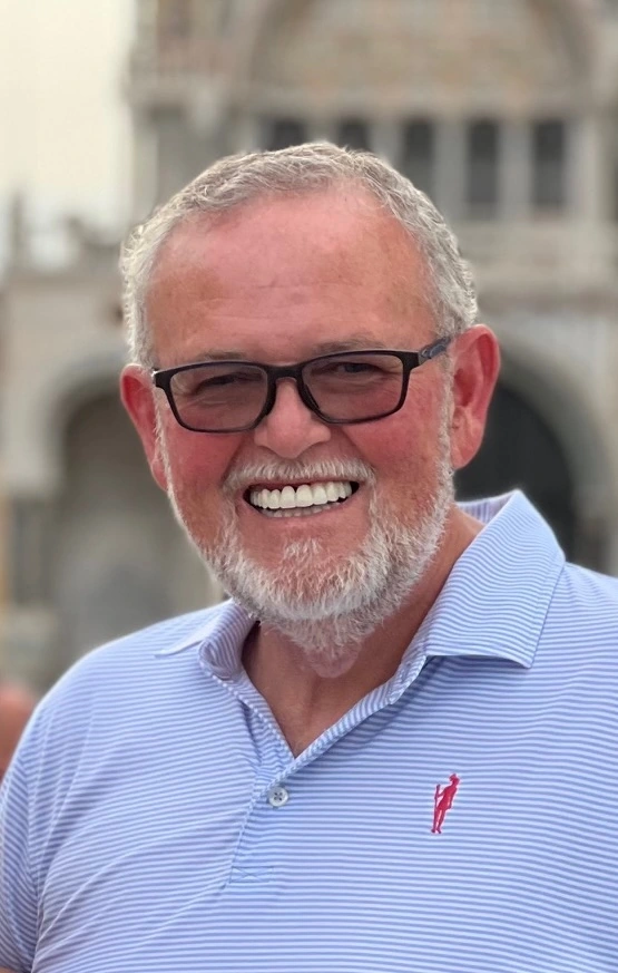 Phoenix Leader - CEO Randy Dean: A smiling older man wearing a blue polo shirt and black rimmed sunglasses.